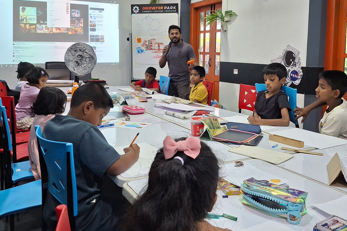 A group of youth in a classroom being taught about local art methods