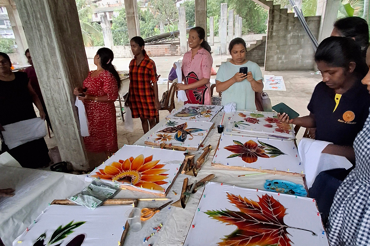 Locals in Sri Lanka view colorful art prints