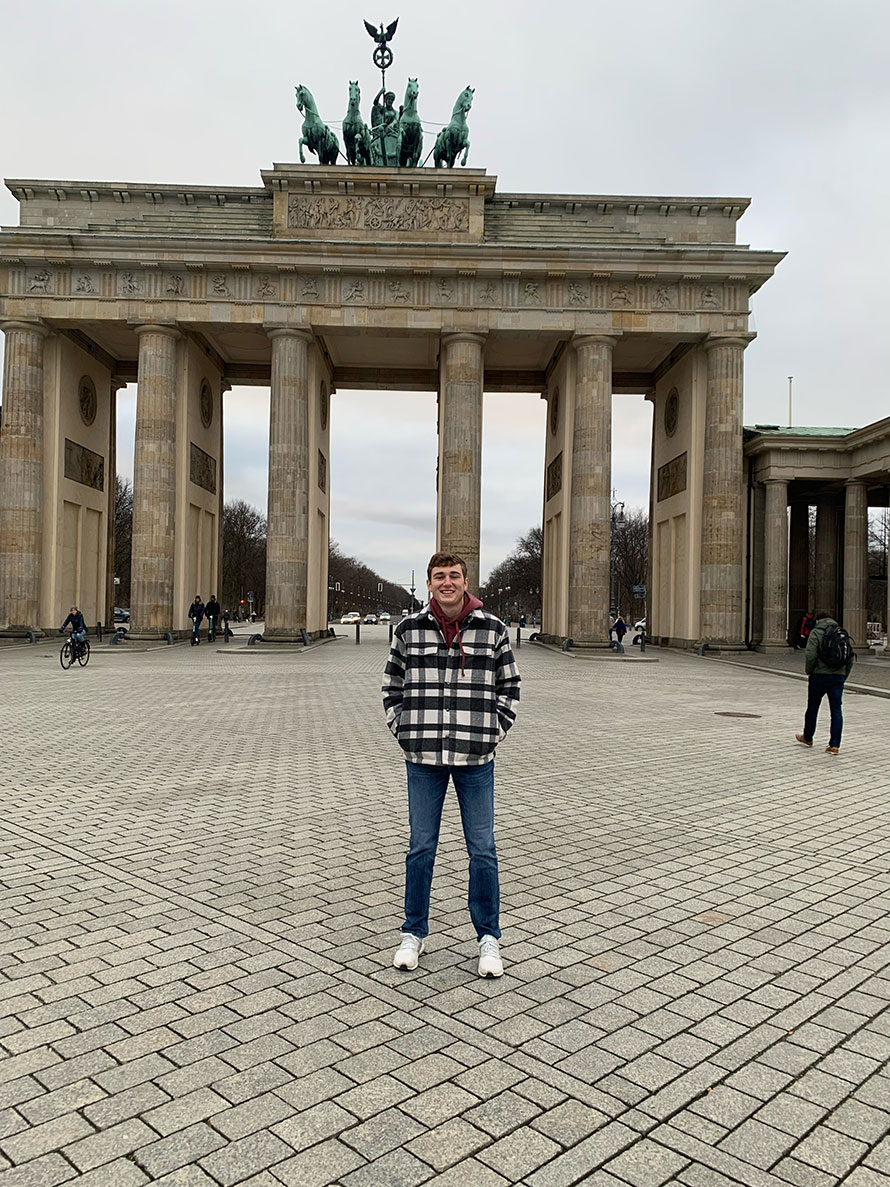 A UNO student stands in front of the Brandenburg Gate in Berlin, Germany