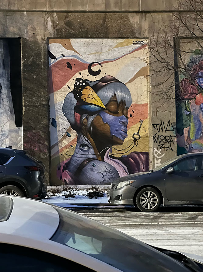 A street art painting of a young woman in Chicago