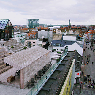 Aerial view of a city with both modern and historic buildings.