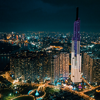 City skyline of skyscrapers and lights at night in Ho Chi Minh City.