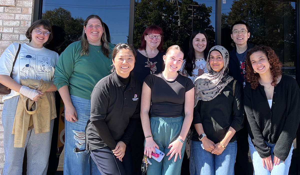 The members of UNO's Education Abroad team pose for a photo outside.