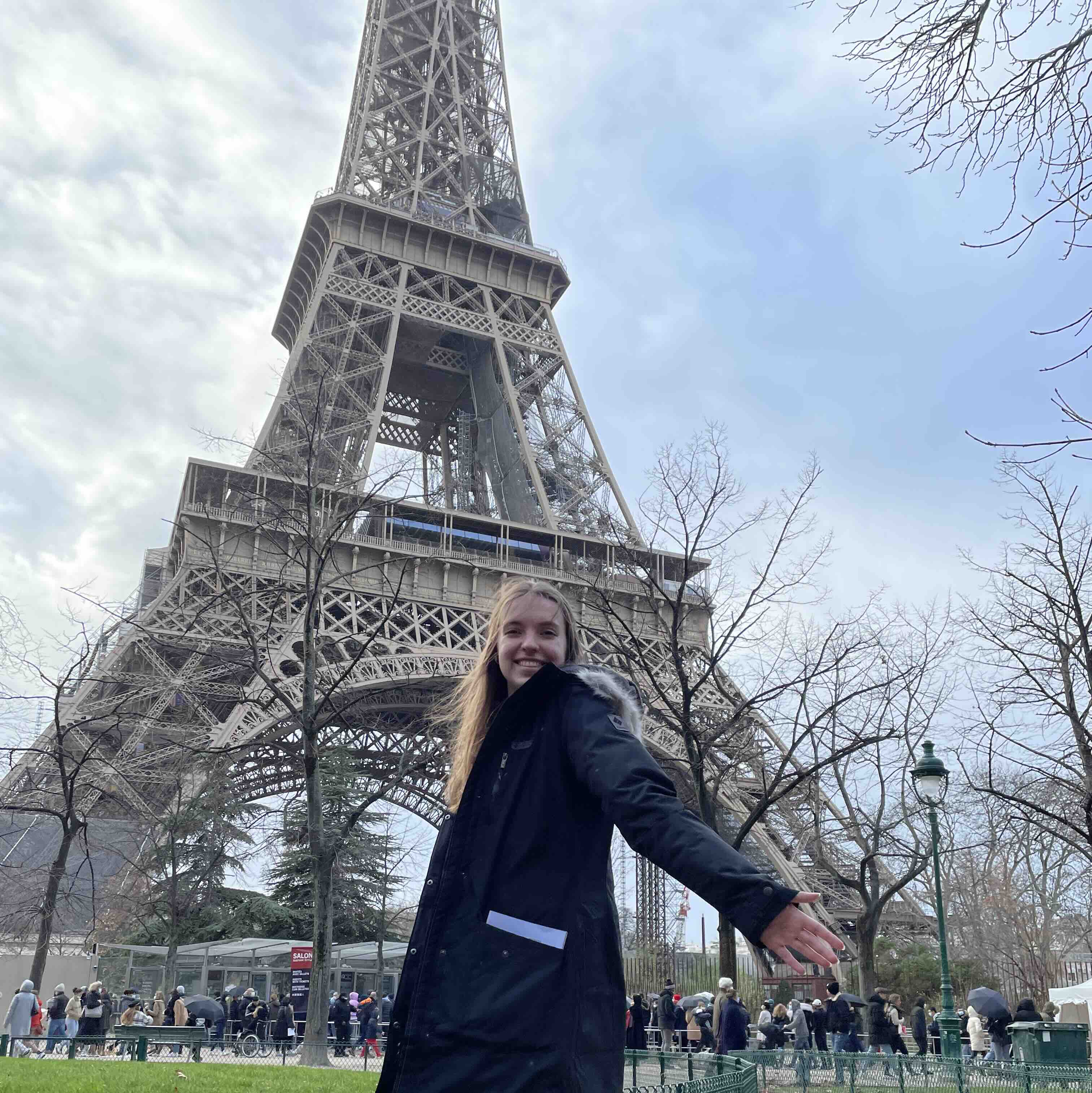 Student standing in front of the Eiffel Tower in Paris