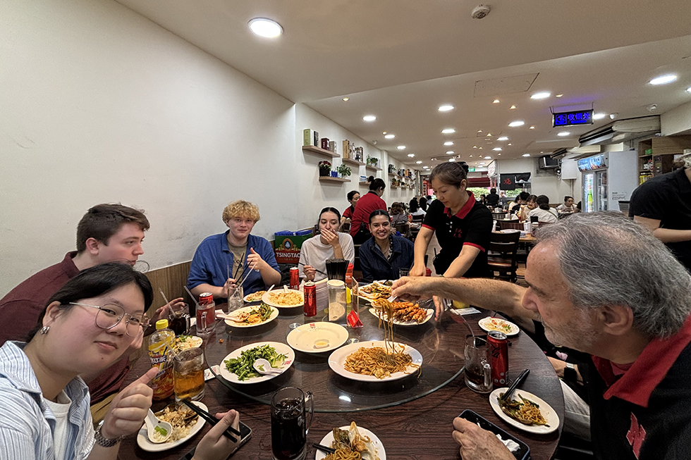 Group sits around a table eating