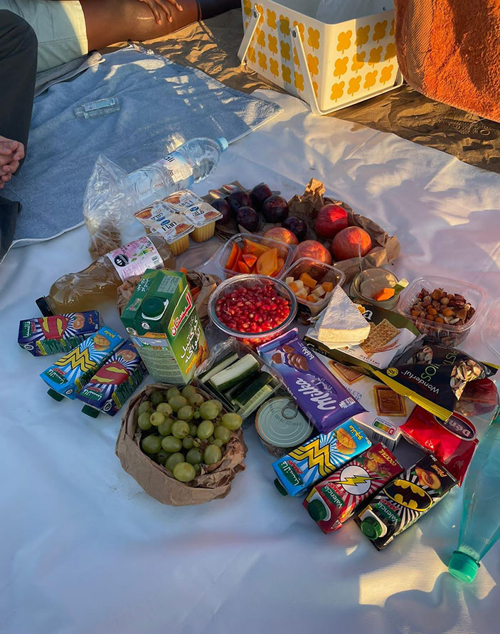 A collection of Morocco snacks spread out on a blanket on the ground