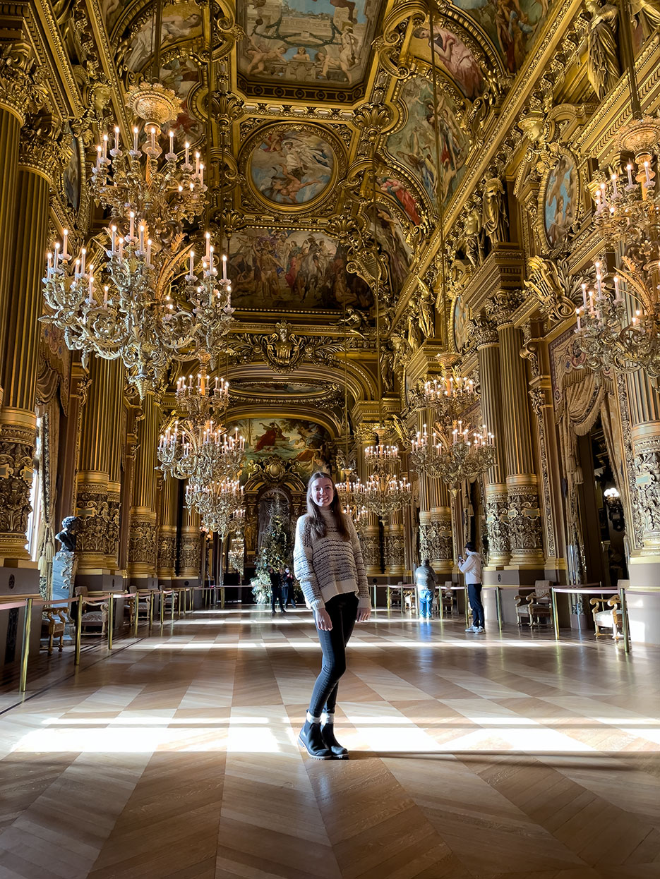 A UNO student poses in an ornate room during her study abroad in France