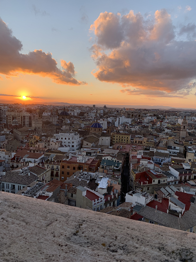 View of the the sun over a Spanish cityscape from above