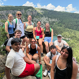 A group of college students pose during a hike.