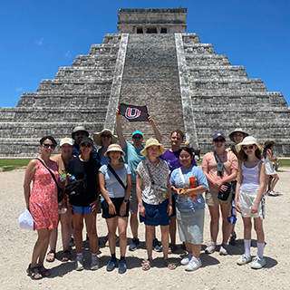 Group posing in front of an ancient step pyramid in Mexico.