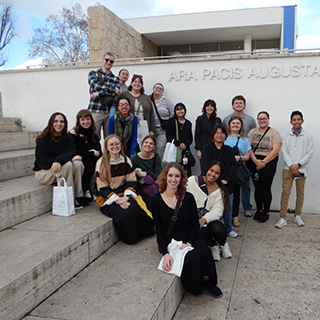 Group poses on the steps outside a building.
