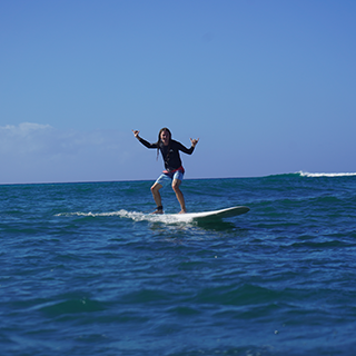 Young man surfing on the ocean.
