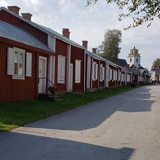 Red and white timber buildings line a street.