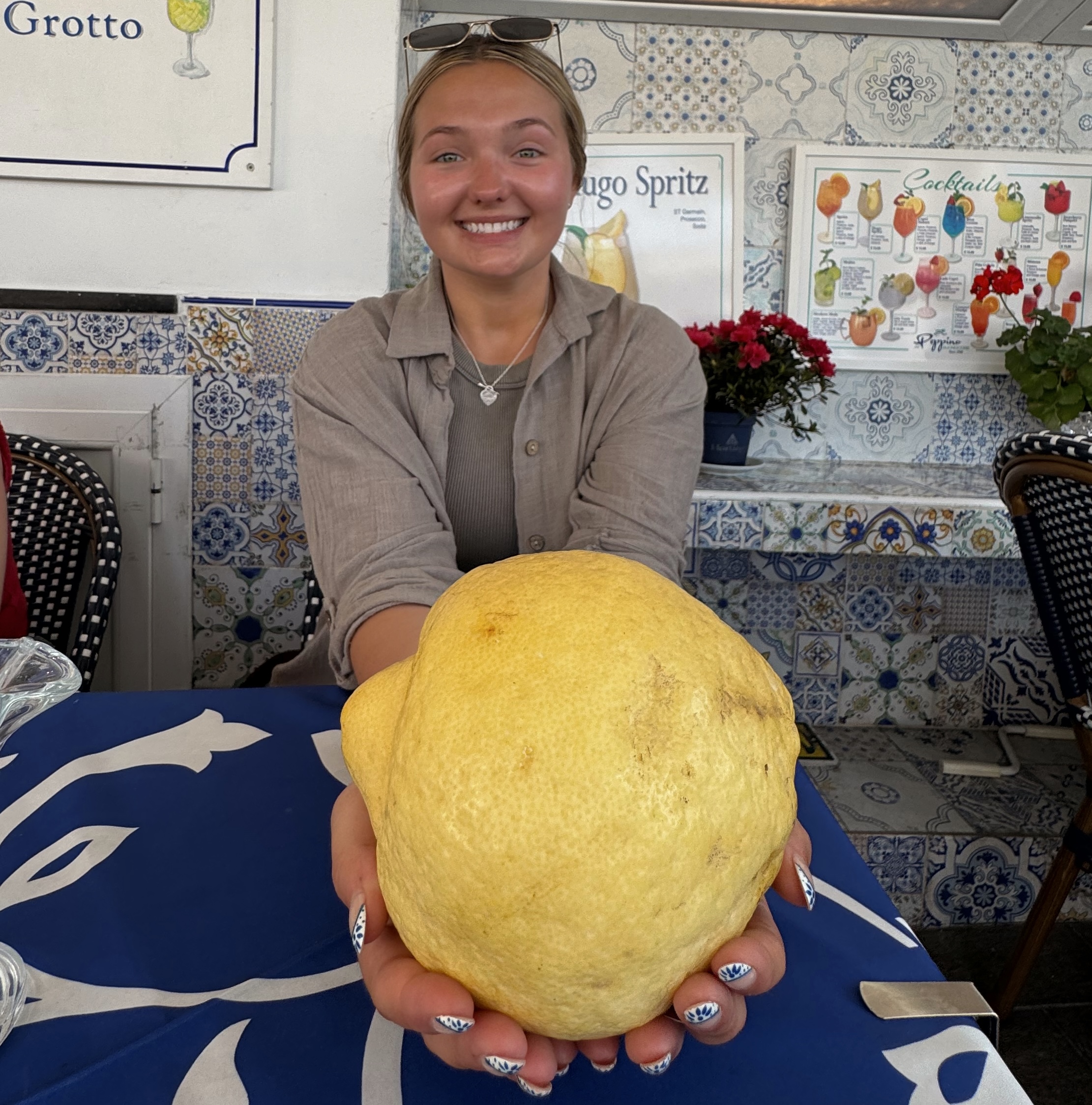 Student holding a large lemon in Italy
