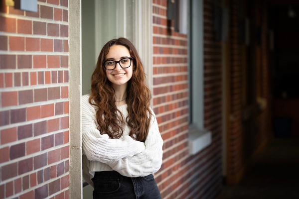 Aislyn Tyler poses near a brick wall