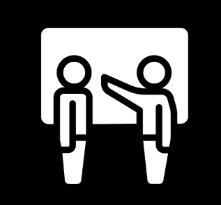 Presentation icon showing one person pointing at a board while another person stands beside it.
