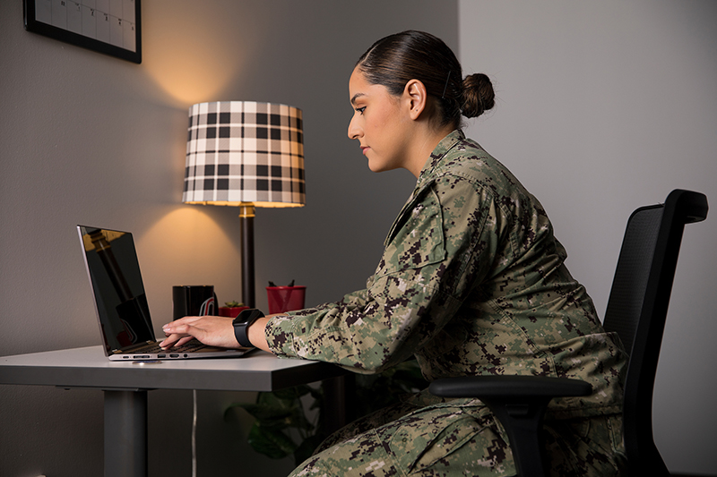 military student working on laptop