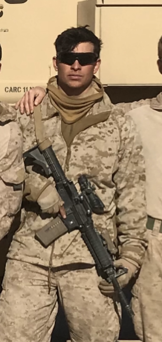 Garrett Parker standing in uniform while on deployment.