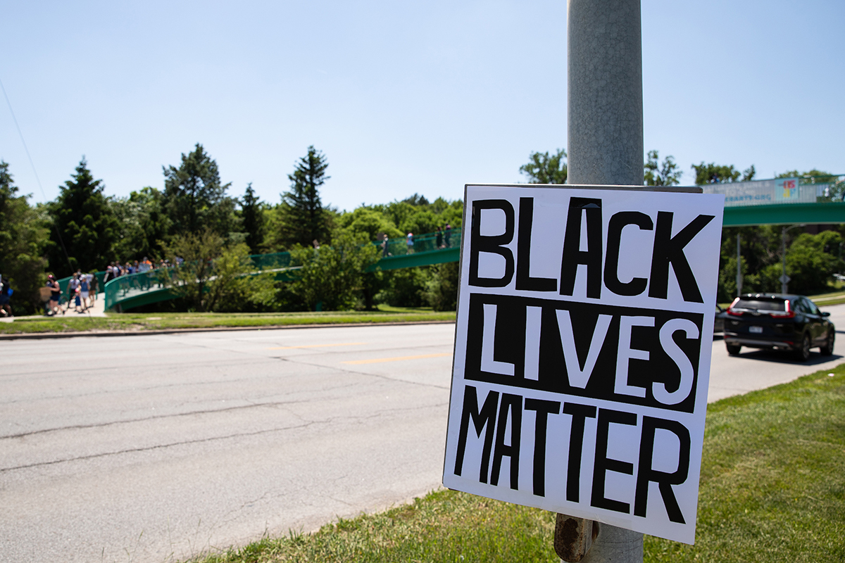 A Black Lives Matter poster hangs on a light pole along Dodge Street