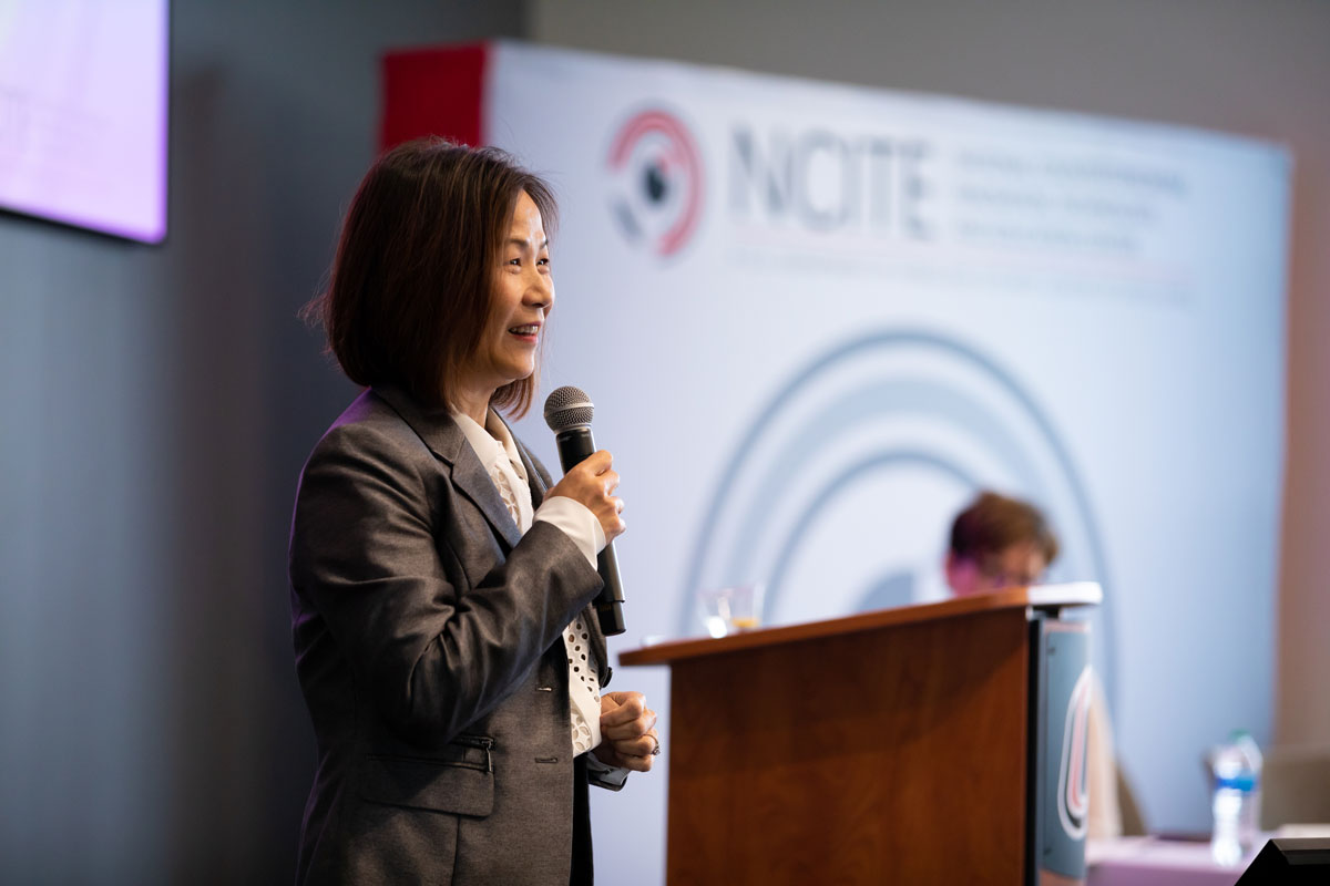 UNO Chancellor Joanne Li speaks on stage. 