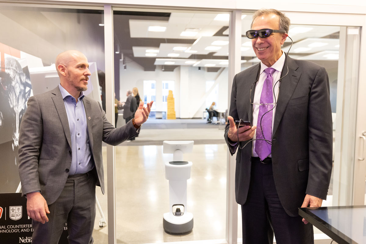 Dimitri Kusnezov wears a VR headset next to NCITE's Sam Hunter. 