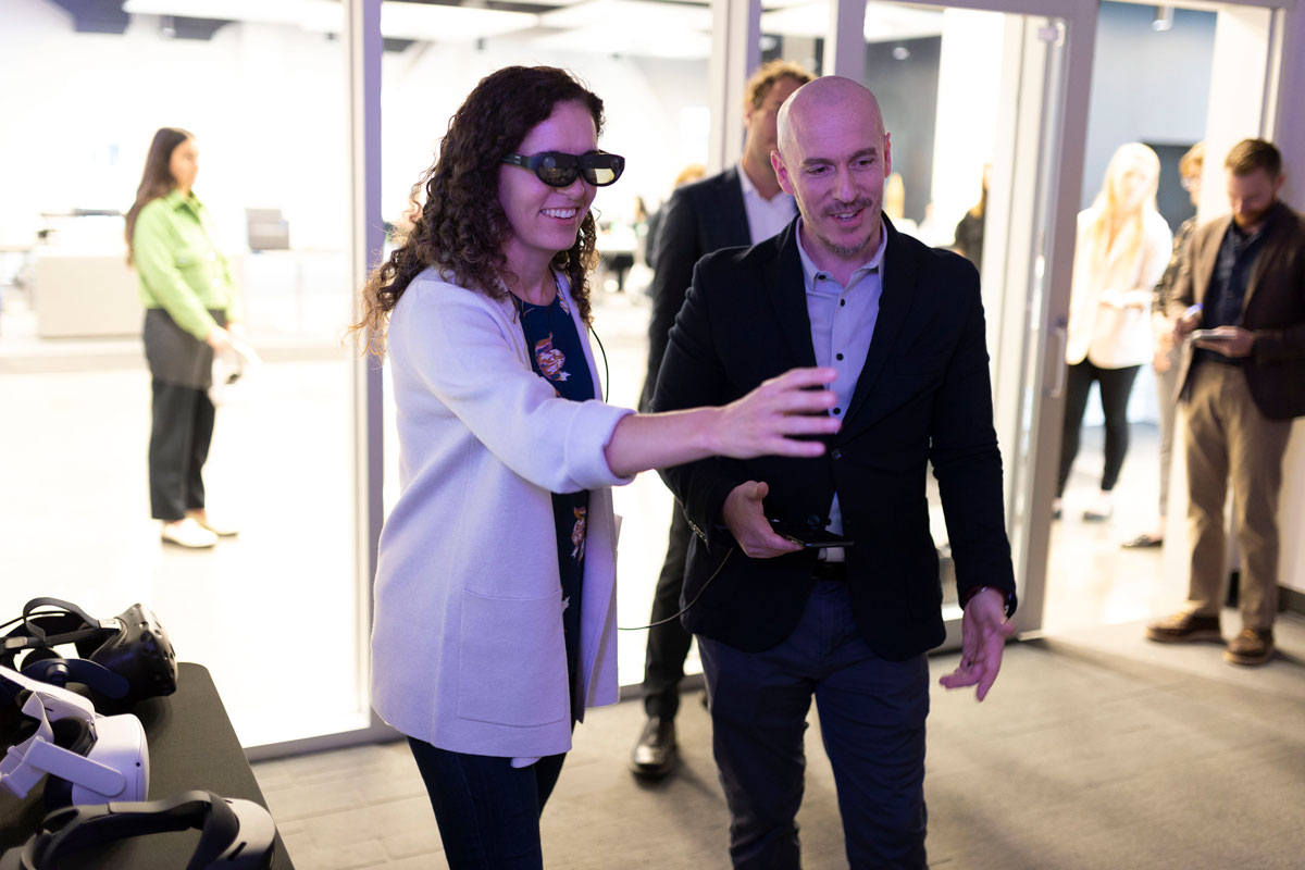 A photo of NCTC director Christy Abizaid and Sam Hunter demonstrating virtual reality technology in Maverick Landing. 