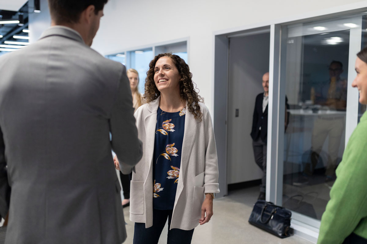 A photo of NCTC director Christy Abizaid shaking hands with NCITE students and researchers.