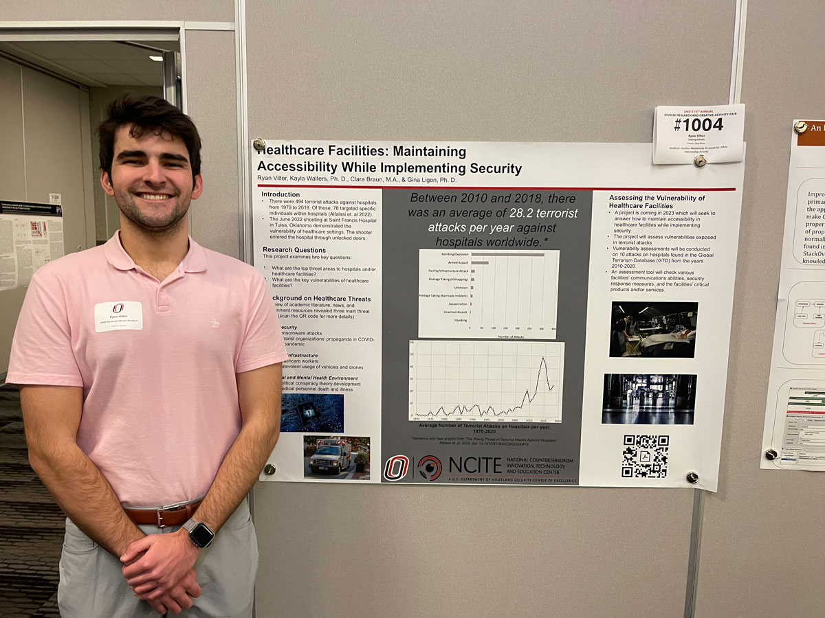 NCITE student Ryan Vilter stands in front of his research poster. 