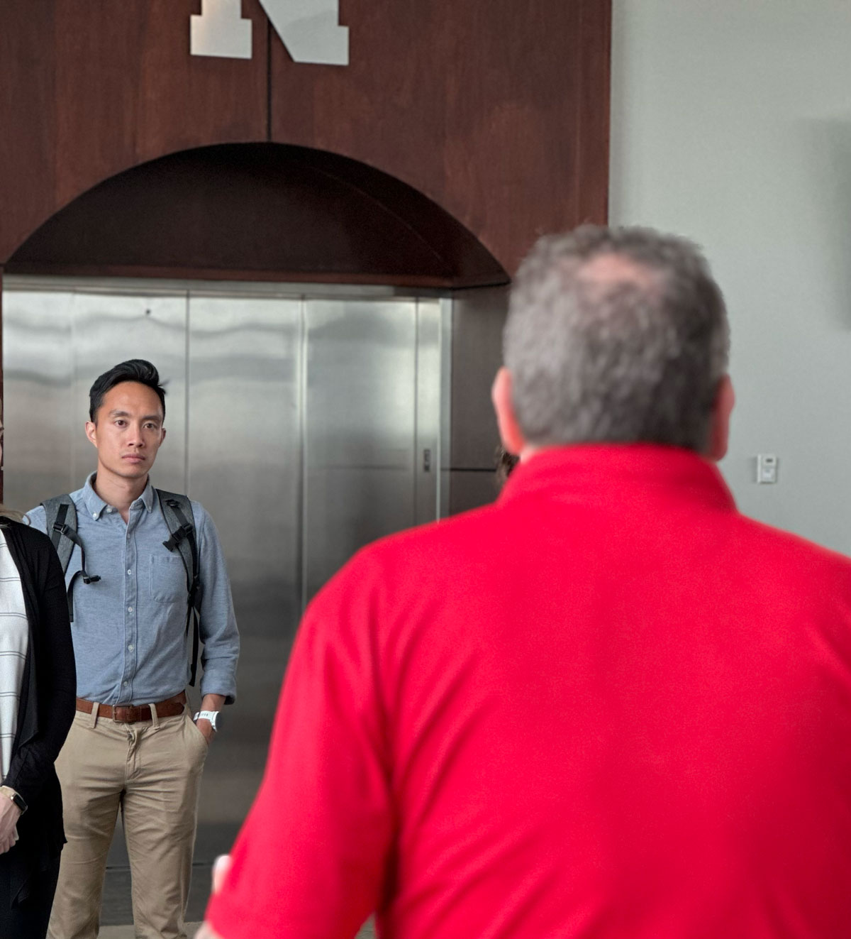 Tin Nguyen watches as Mario Scalora explains security procedures at Memorial Stadium. 