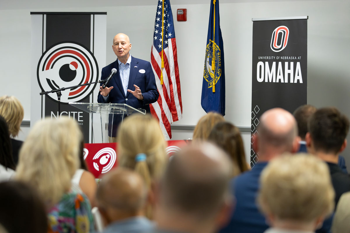 U.S. Sen. Pete Ricketts addresses the crowd from the podium at the Scott Technology Center.
