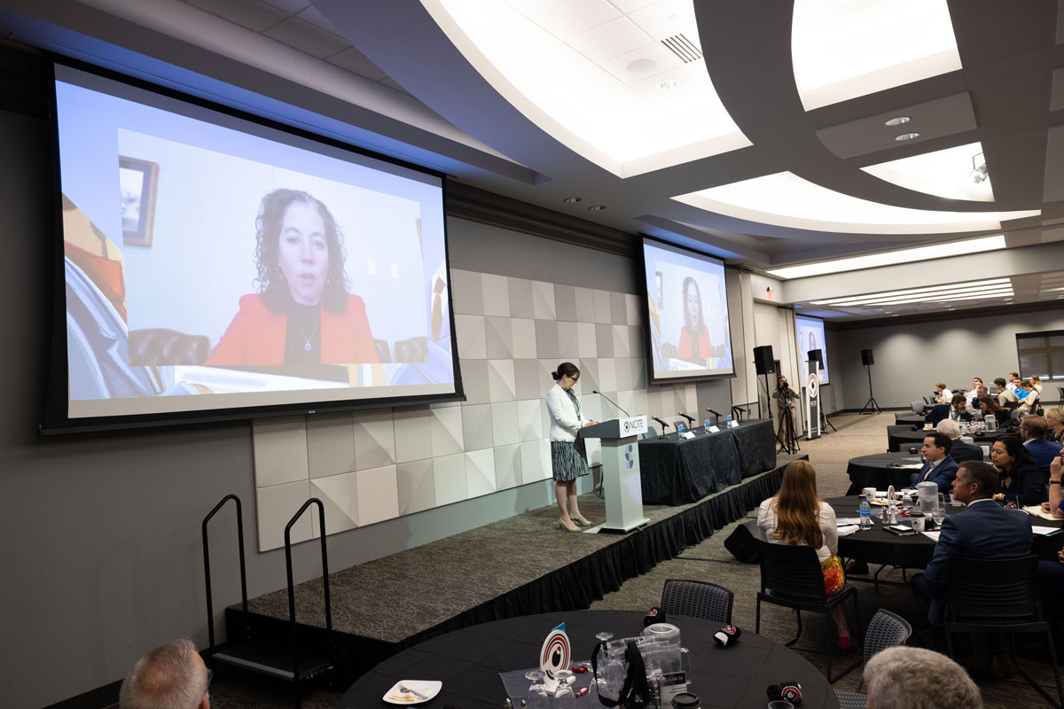 Jen Daskal speaks on a projector screen at ENVISION24.