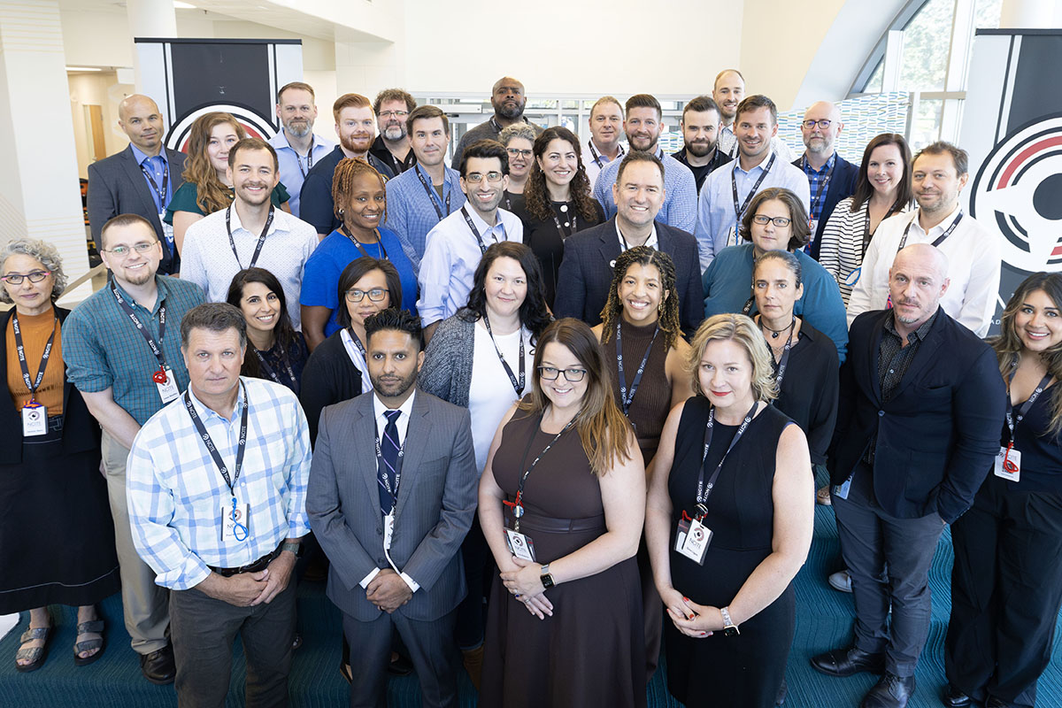 A group shot featuring attendees of NCITE's workshop, held on Sept. 11, 2024. The NCITE logo is visible on a banner to the right. 
