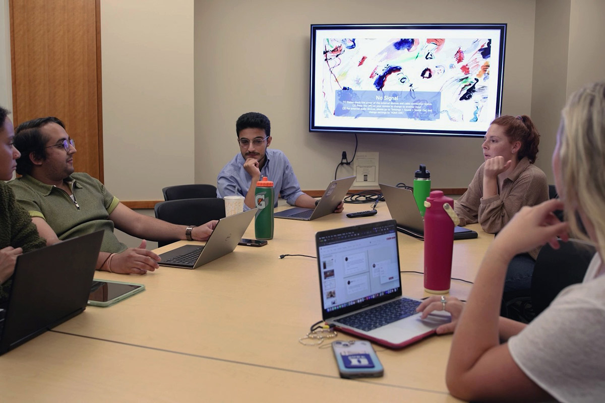 Students gather around a table to discuss issues of national security and the work being done at UNO and Duke.