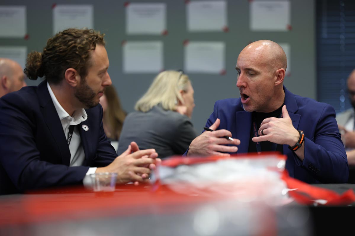 Two attendees engage in conversation during a breakout discussion at the advisory board summit.