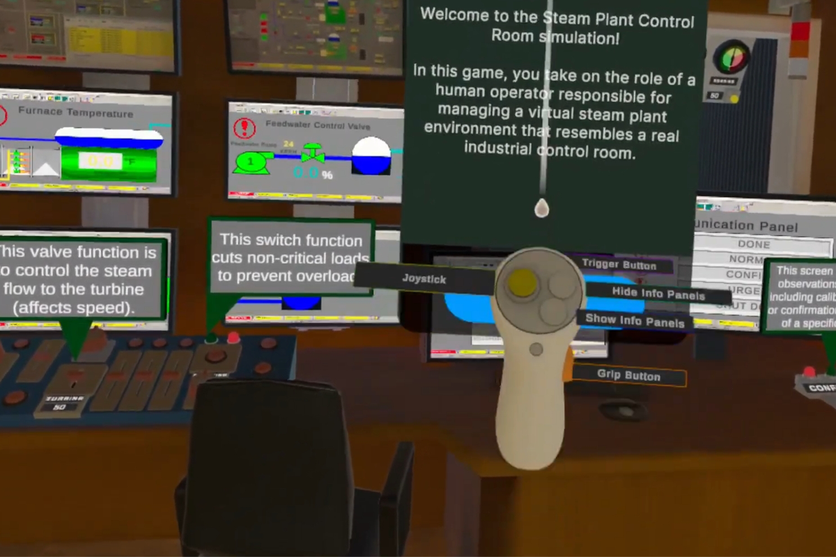 A first-person view inside a virtual reality training environment that simulates an industrial steam plant control room. Multiple control panels, gauges, and monitoring screens surround a virtual workstation. Instructional text explains the simulation, and a virtual hand controller is visible for interacting with controls and equipment.