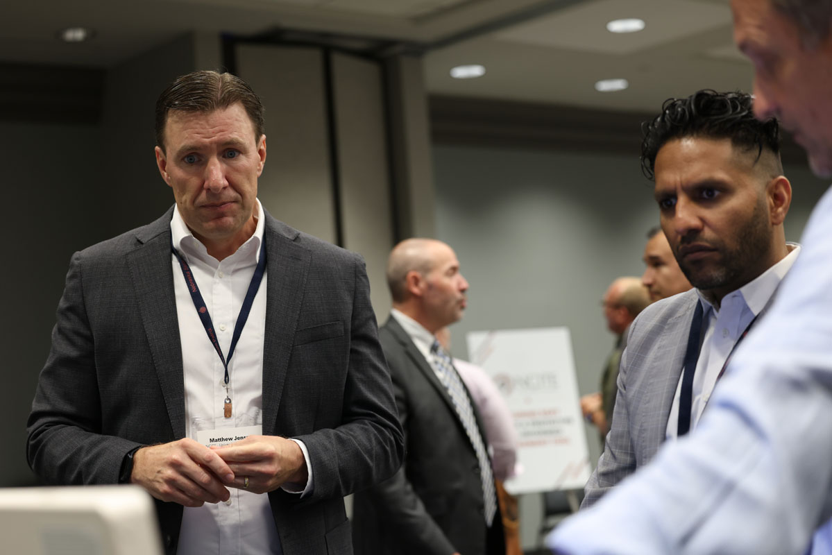 Two attendees engage in conversation during a breakout discussion at the advisory board summit.