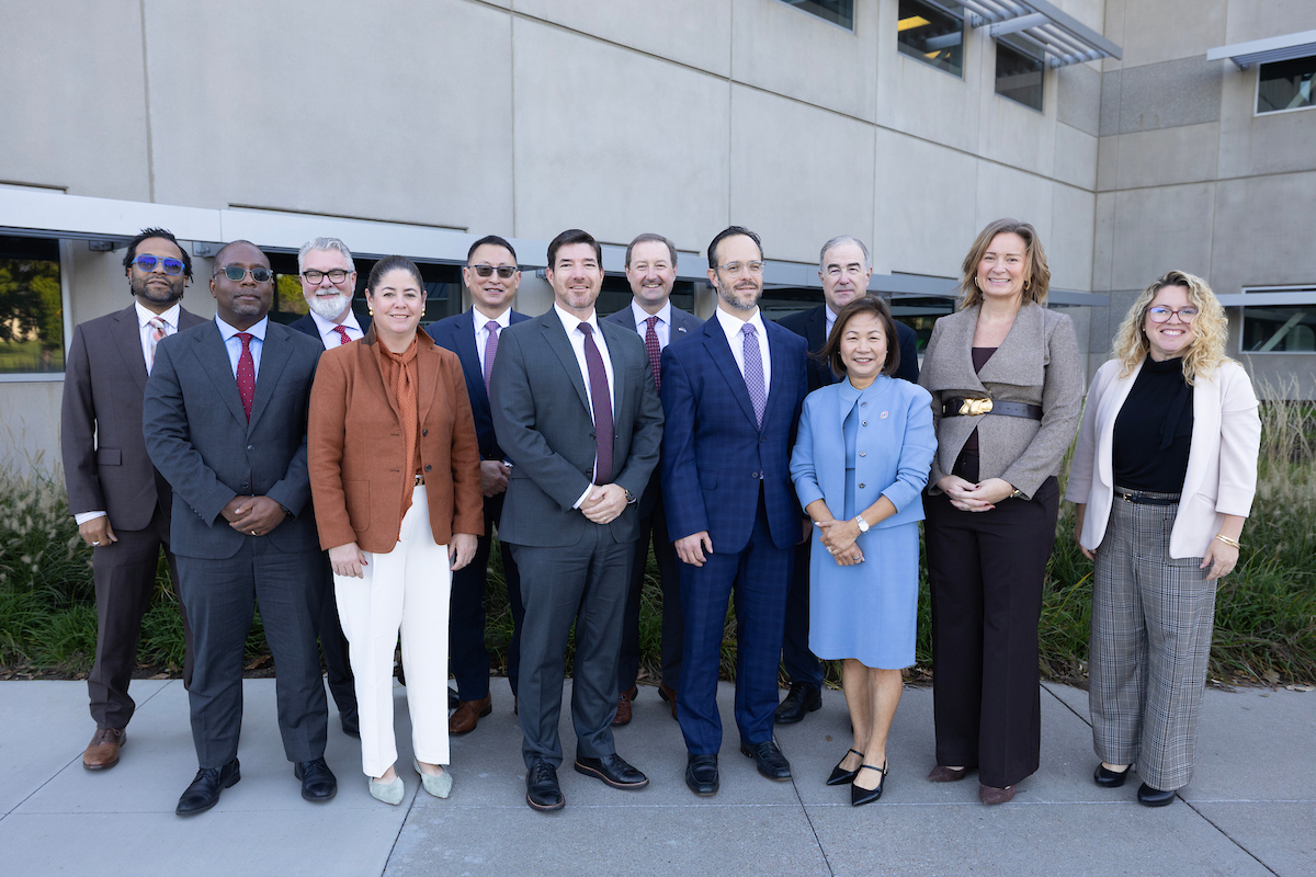 NCITE, UNO and DHS S&T leaders pose for a photo outside NCITE's headquarters at Scott Campus.  