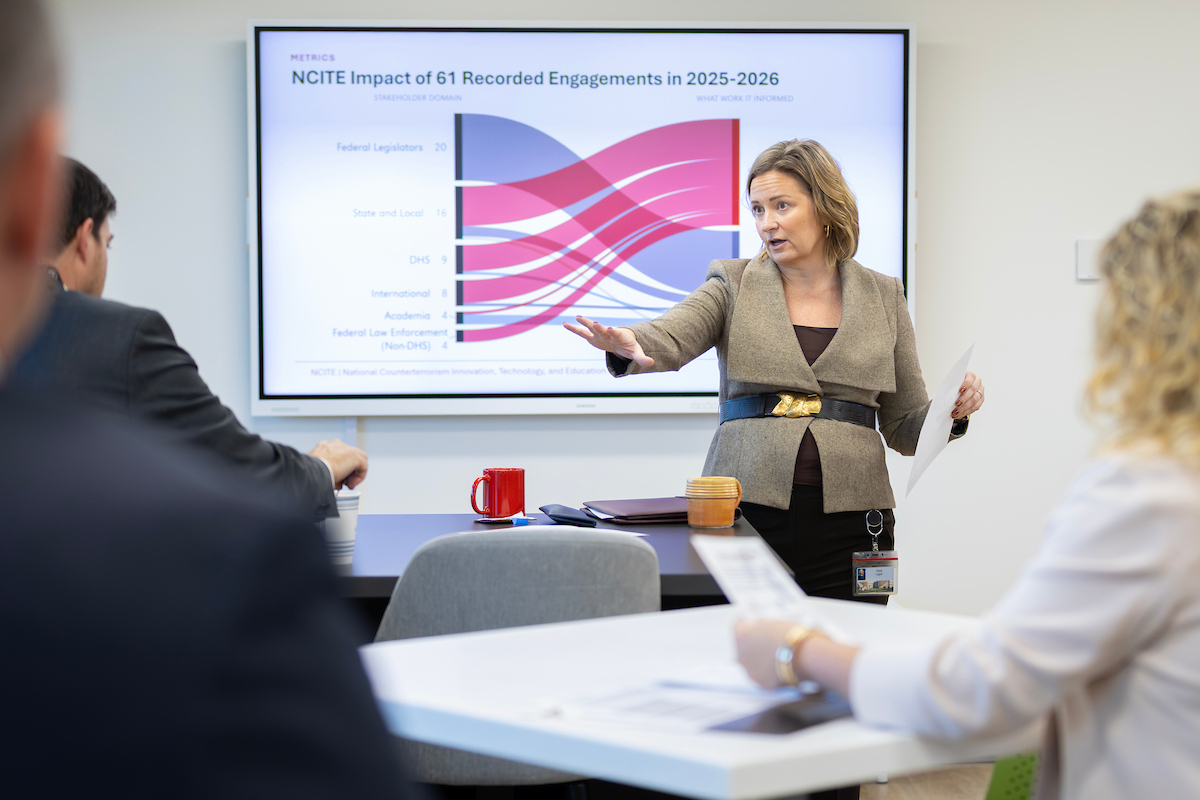NCITE Director Gina Ligon gestures while presenting data on the center’s 61 recorded stakeholder engagements in 2025–2026 to government and university leaders at NCITE headquarters in Omaha.