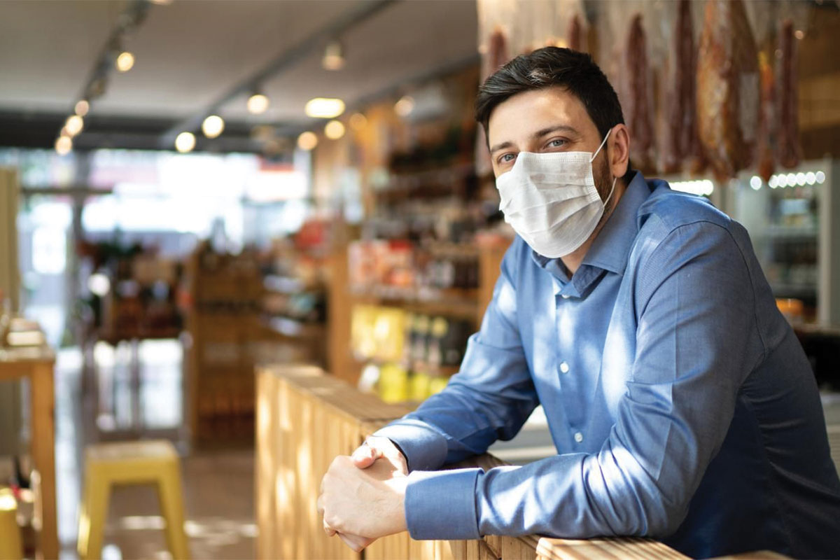 Male with mask waiting for customers