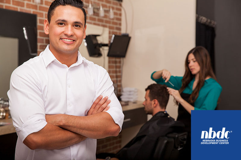 Male salon owner smiling