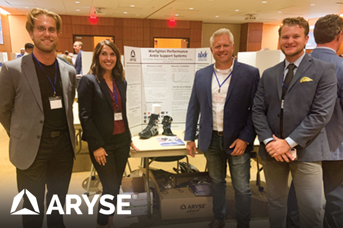 Staff from ARYSE standing in front of their pitch board.