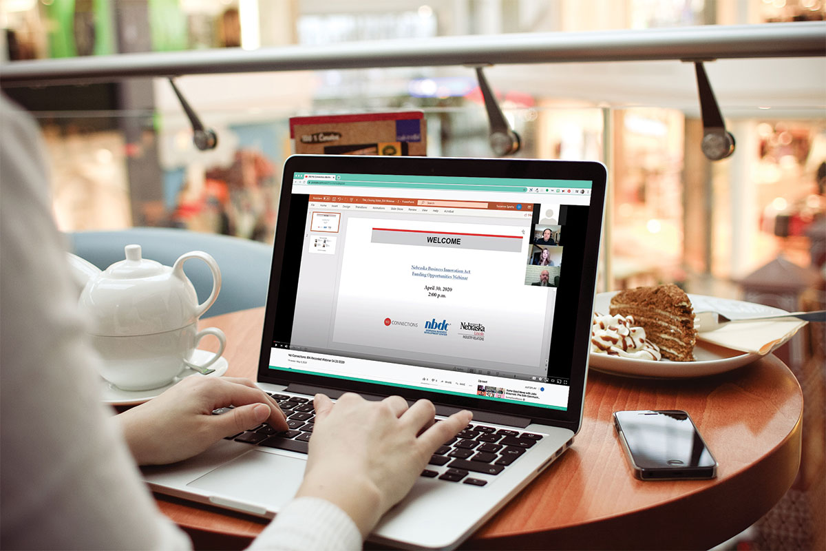 Person watching webinar on laptop