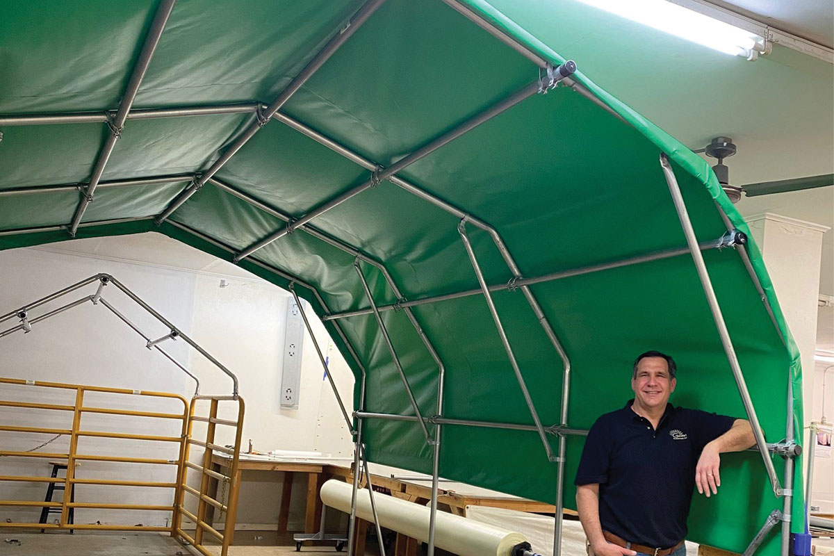 Genesis Enterprises owner, Kevin Connot, standing under one his company's canopy.