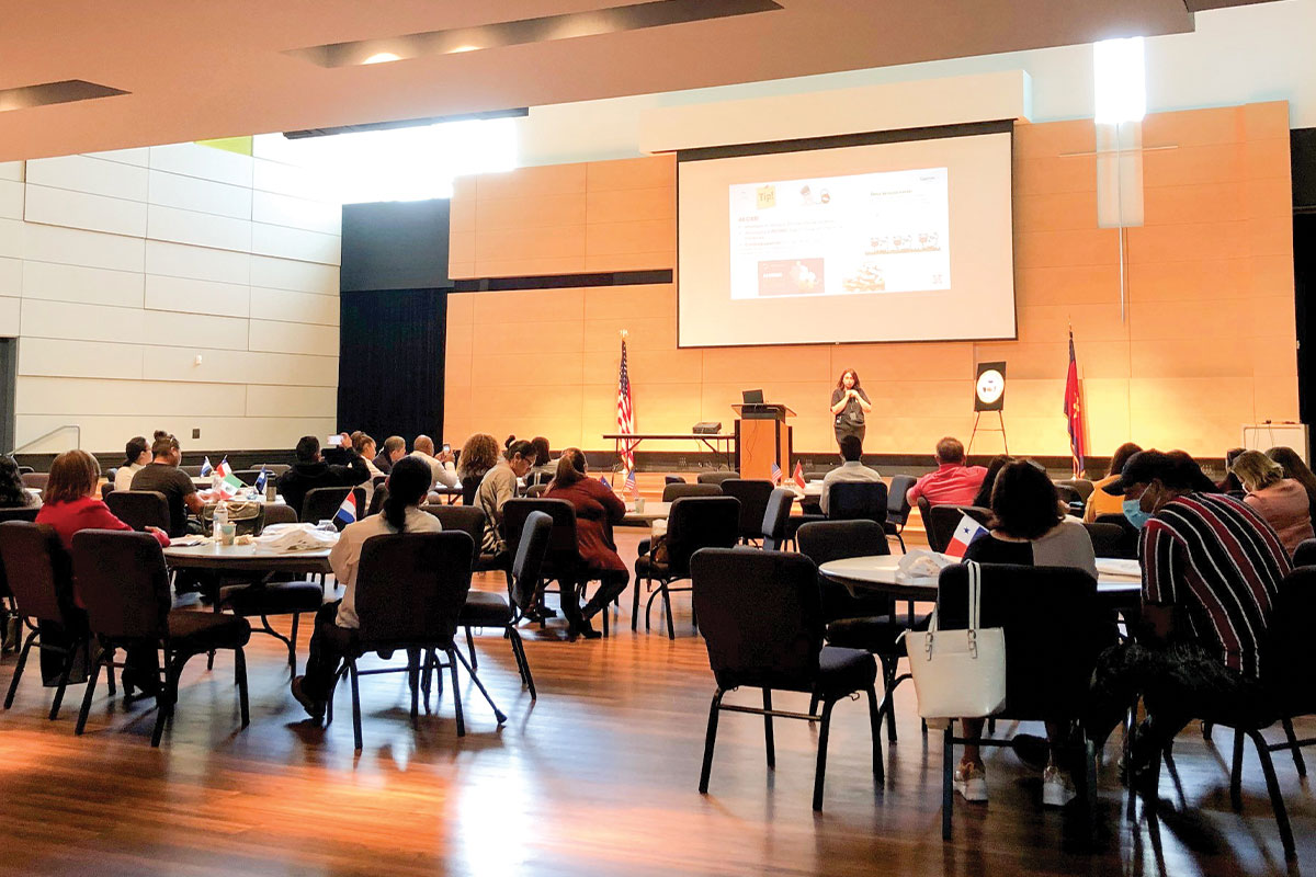 Latino Small Business Conference. Attendees listen to a female presenter.