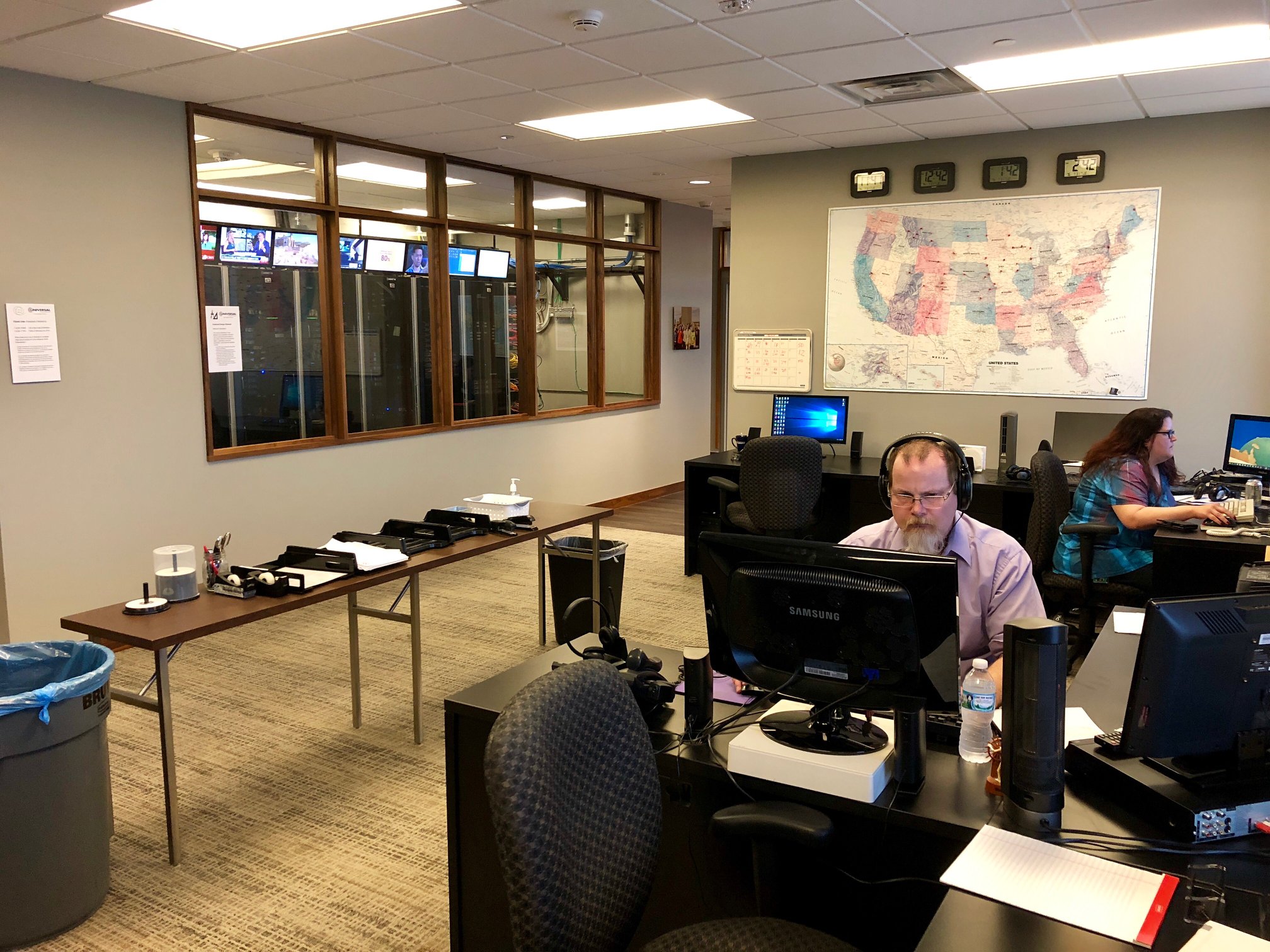 Universal Information Services office building with workers at desks