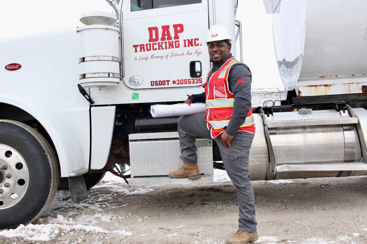 William Page next to one of the trucks in his fleet. 