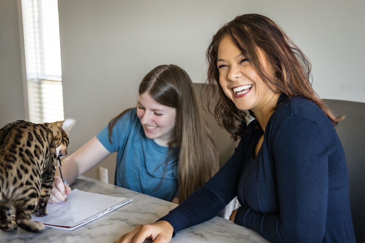 Great Thinkers Learning Academy Owner Danielle McGlynn laughing with daughter while studying