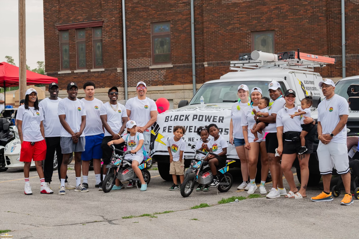 Black Power Redevelopers Team in Omaha, Nebraska posing for a picture during a parade.