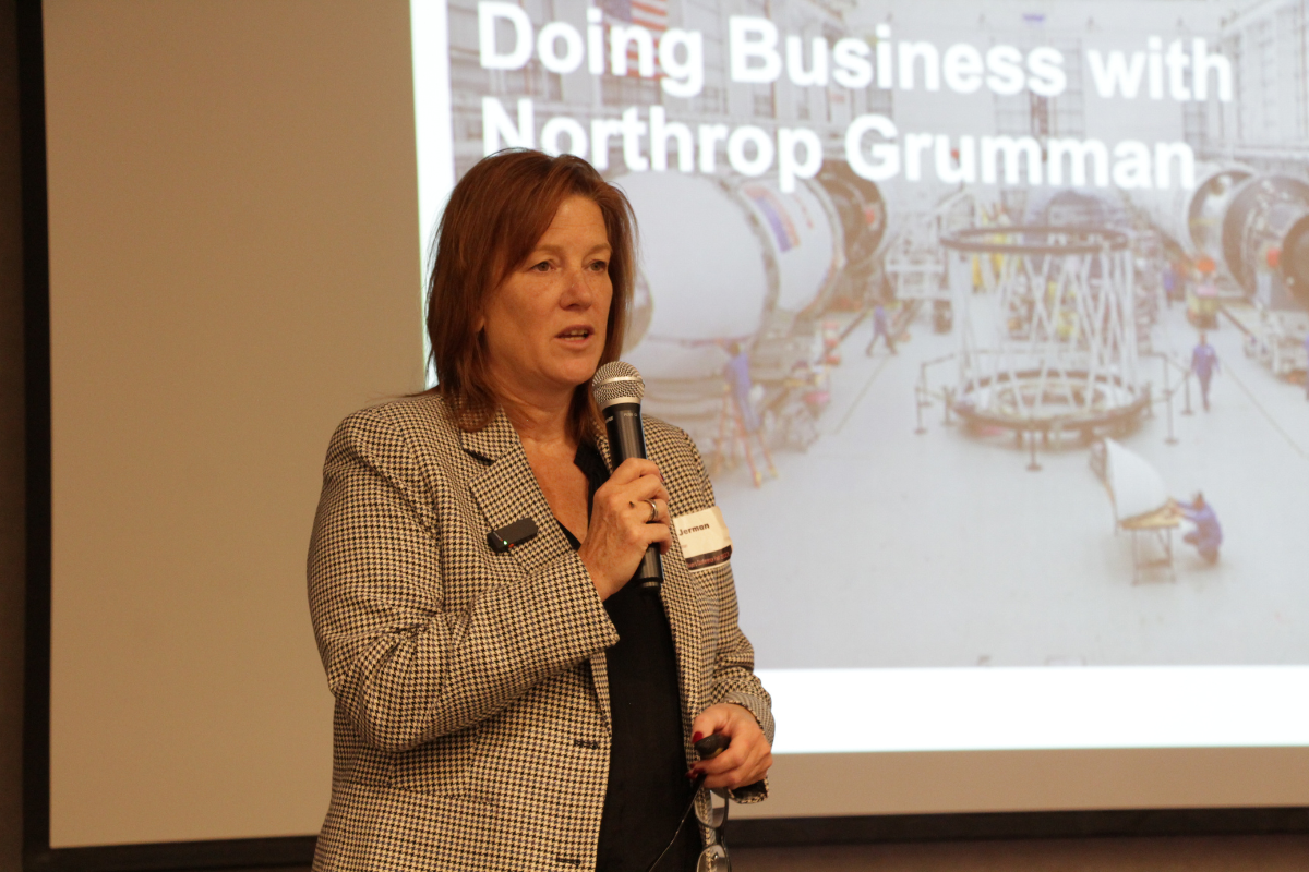 Tracy Jerman speaking with a microphone about Doing Business with Northrop Grumman