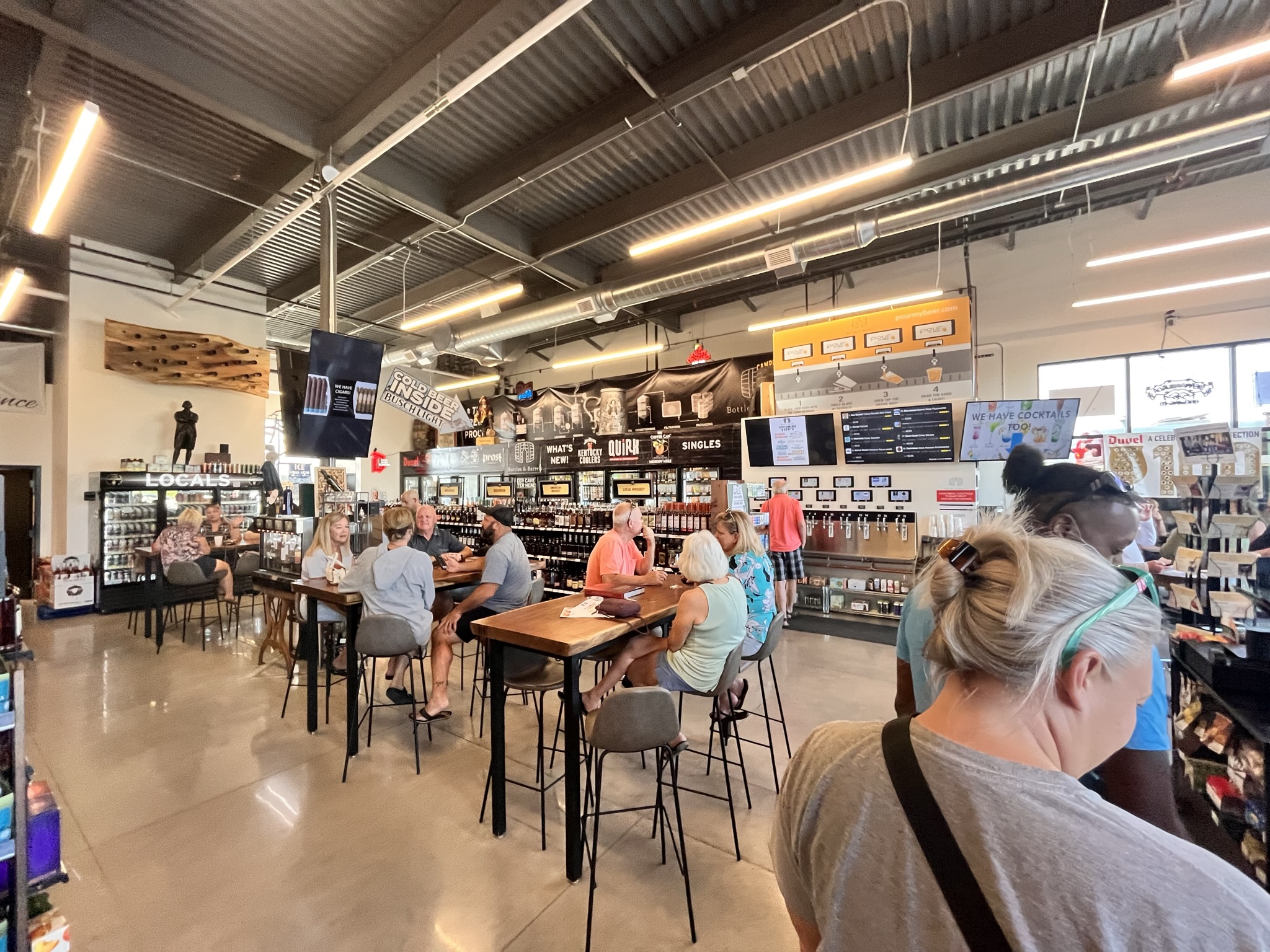 Customers enjoy sampling beverages at Bottles & Barrels, LLC.